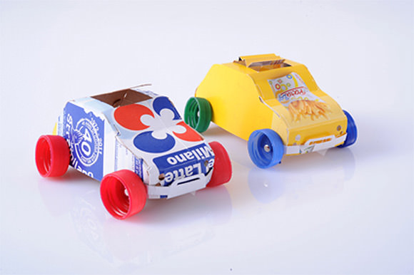 Recycled juice cartons and plastic bottle caps make great toy cars!