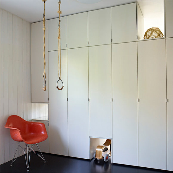 Cool built-in storage in a playroom - love the rings!