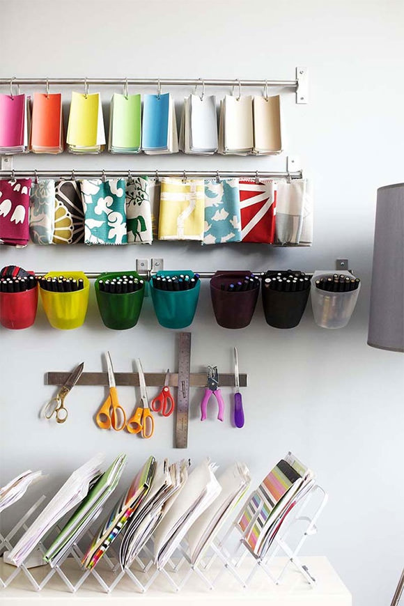 Organized swatches and a magnetic strip for tools in a craft studio / workspace