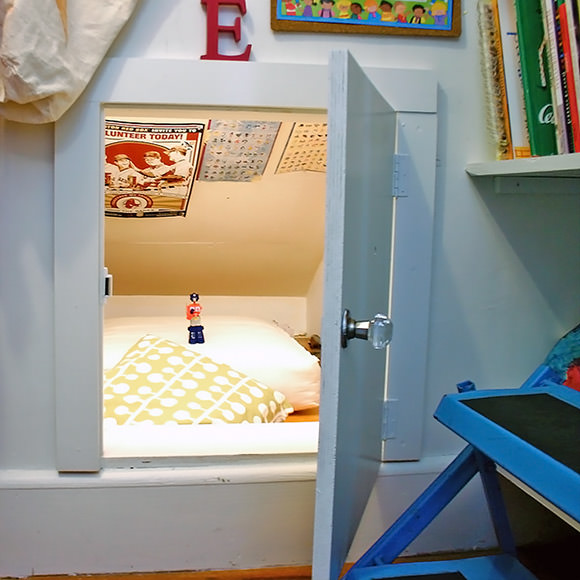 A low-ceiling crawl space transformed into a secret hideaway in a kid's room