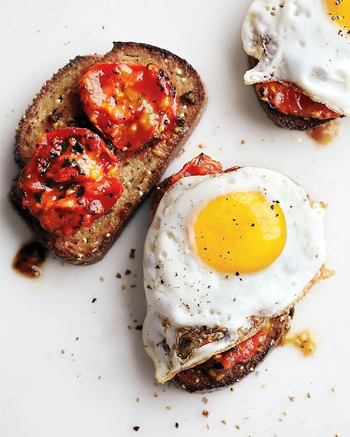 Breakfast Sandwich Recipe: Charred Tomatoes with Fried Eggs on Garlic Toast (via MarthaStewart.com)